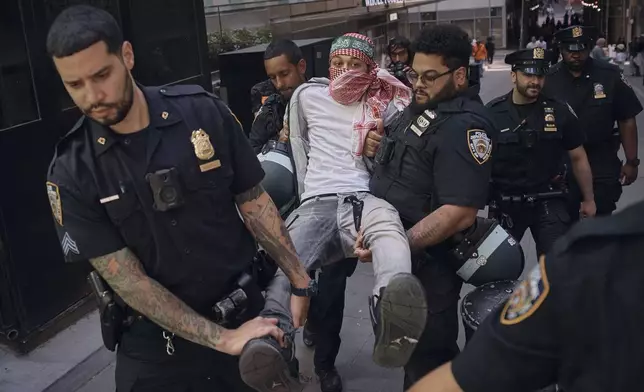 Police arrest a protester during a pro-Palestinian demonstration calling for an economic blockade and demanding a cease-fire on the Israel-Palestinian conflict outside The New York Stock Exchange on Monday, April 15, 2024, in New York. (AP Photo/Andres Kudacki)