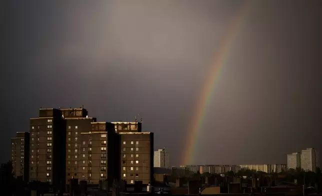 A rainbow appears in the sky over residents buildings in the German capital during a thunderstorm in Berlin, Tuesday, April 16, 2024. (AP Photo/Markus Schreiber)