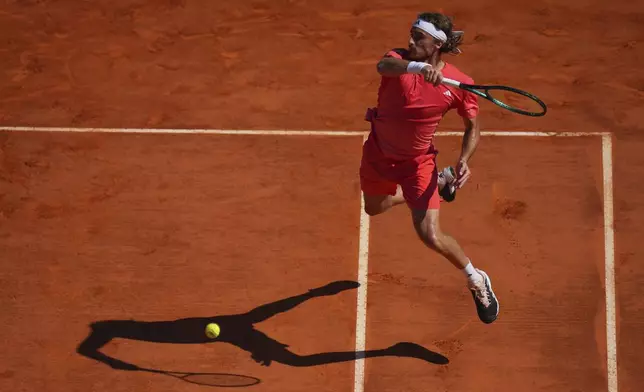 Stefanos Tsitsipas of Greece returns the ball to Casper Ruud of Norway during their Monte Carlo Tennis Masters final match in Monaco, Sunday, April 14, 2024. (AP Photo/Daniel Cole)