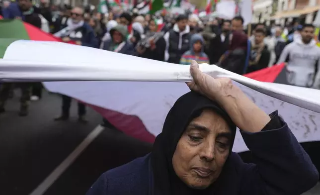 Pro-Palestinian protesters take part at a demonstration on Al Quds Day, in London, Friday, April 5, 2024. (AP Photo/Kin Cheung)