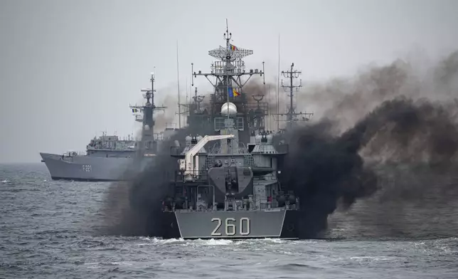 A Romanian warship sails engulfed in smoke during a Romanian Navy led exercise outside Constanta, Romania, Tuesday, April 16, 2024. The exercise, dubbed "Sea Shield 2024," brought together U.S. and NATO troops and involved some 2,200 military personnel from 12 allied and partner states. (AP Photo/Andreea Alexandru)