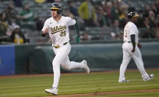 Oakland Athletics' Brent Rooker (25) runs home to score during the fourth inning of a baseball game against the Pittsburgh Pirates in Oakland, Calif., Monday, April 29, 2024. (AP Photo/Jeff Chiu)