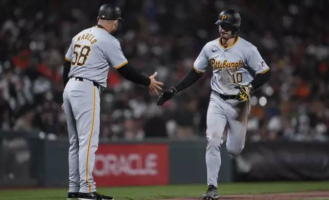 Pittsburgh Pirates' Bryan Reynolds, right, celebrates with third base coach and field coordinator Mike Rabelo, left, after hitting a two-run home run against the San Francisco Giants during the 10th inning of a baseball game Saturday, April 27, 2024, in San Francisco. (AP Photo/Godofredo A. Vásquez)