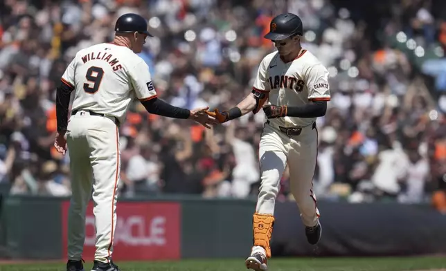 San Francisco Giants' Mike Yastrzemski, right, celebrates with third base coach Matt Williams after hitting a solo home run off Pittsburgh Pirates pitcher Jared Jones during the third inning of a baseball game Sunday, April 28, 2024, in San Francisco. (AP Photo/Godofredo A. Vásquez)