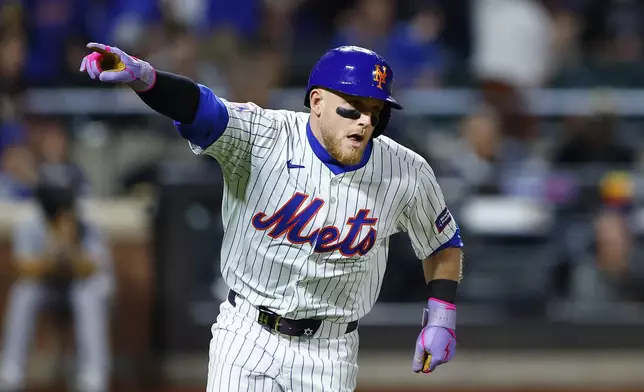 New York Mets' Harrison Bader reacts after hitting a double against the Pittsburgh Pirates during the eighth inning of a baseball game, Monday, April 15, 2024, in New York. (AP Photo/Noah K. Murray)