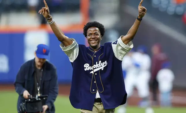 Busaro Robinson, grandson of Jackie Robinson, reacts after throwing the ceremonial first pitch on Jackie Robinson Day before a baseball game between the New York Mets and the Pittsburgh Pirates Monday, April 15, 2024, in New York. (AP Photo/Noah K. Murray)