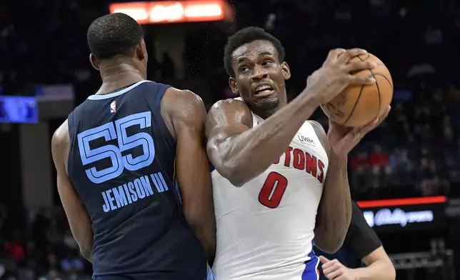 Detroit Pistons center Jalen Duren (0) handles the ball against Memphis Grizzlies center Trey Jemison (55) in the second half of an NBA basketball game Friday, April 5, 2024, in Memphis, Tenn. (AP Photo/Brandon Dill)