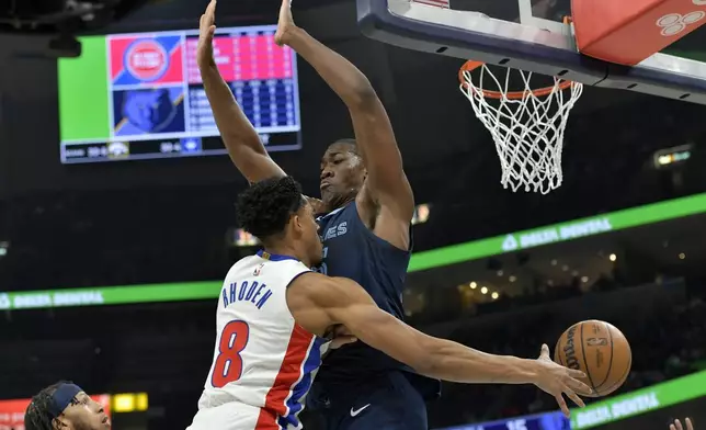 Detroit Pistons guard Jared Rhoden (8) passes around Memphis Grizzlies center Trey Jemison in the first half of an NBA basketball game Friday, April 5, 2024, in Memphis, Tenn. (AP Photo/Brandon Dill)