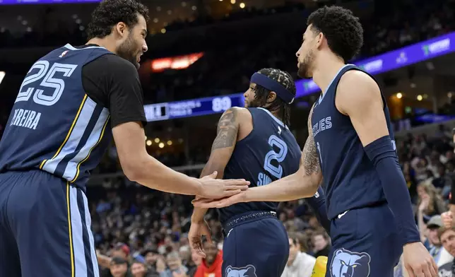 Memphis Grizzlies forward Maozinha Pereira (25), guard Zavier Simpson (2) and guard Scotty Pippen Jr., right, react in the second half of an NBA basketball game against the Detroit Pistons, Friday, April 5, 2024, in Memphis, Tenn. (AP Photo/Brandon Dill)