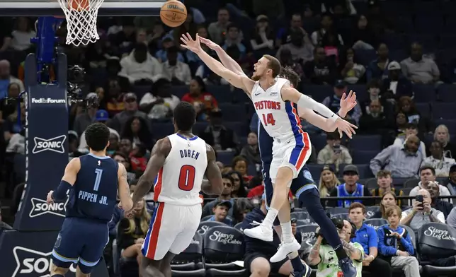 Detroit Pistons guard Malachi Flynn (14) shoots against the Memphis Grizzlies in the second half of an NBA basketball game Friday, April 5, 2024, in Memphis, Tenn. (AP Photo/Brandon Dill)