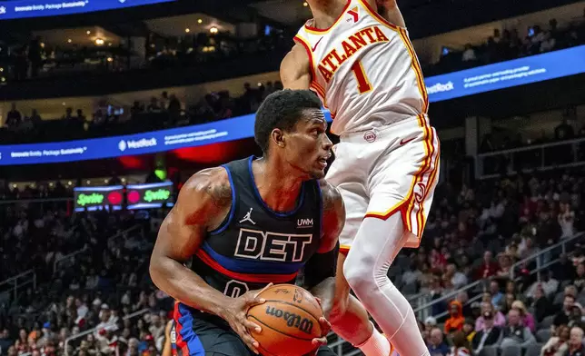 Detroit Pistons center Jalen Duren (0) goes to the basket against Atlanta Hawks forward Jalen Johnson (1) during the first half of an NBA basketball game, Wednesday, April 3, 2024, in Atlanta. (AP Photo/Jason Allen)