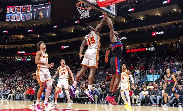 Atlanta Hawks center Clint Capela (15) blocks a shot by Detroit Pistons center Jalen Duren (0) during the first half of an NBA basketball game, Wednesday, April 3, 2024, in Atlanta. (AP Photo/Jason Allen)