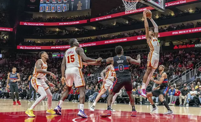 Atlanta Hawks forward Jalen Johnson (1) grabs the rebound during the first half of an NBA basketball game against the Detroit Pistons, Wednesday, April 3, 2024, in Atlanta. (AP Photo/Jason Allen)