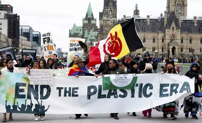 FILE - People participate in a March to End the Plastic Era on Parliament Hill in Ottawa, Ontario, on April 21, 2024. (Spencer Colby/The Canadian Press via AP, File)