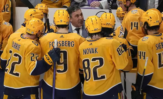 FILE - Nashville Predators head coach Andrew Brunette, center, gives instruction to his players during a timeout in the third period of an NHL hockey game against the Vancouver Canucks, Tuesday, Oct. 24, 2023, in Nashville, Tenn. Vancouver won 3-2. Of the 16 teams entering the NHL playoffs this weekend, seven feature coaches who are in their first full year or hired as midseason replacements.(AP Photo/George Walker IV, File)