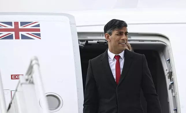 Britain's Prime Minister Rishi Sunak arrives at Warsaw Chopin airport in Warsaw, Poland, Tuesday April 23, 2024. (Henry Nicholls/Pool via AP)