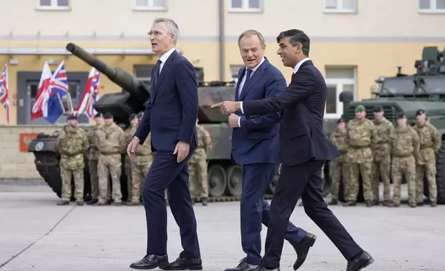 Britain's Prime Minister Rishi Sunak, right, Poland's Prime Minister Donald Tusk and NATO Secretary General Jens Stoltenberg, left, arrive together at the Armourd Brigade barracks in Warsaw, Poland, Tuesday, April 23, 2024.(AP Photo/Alastair Grant, Pool)