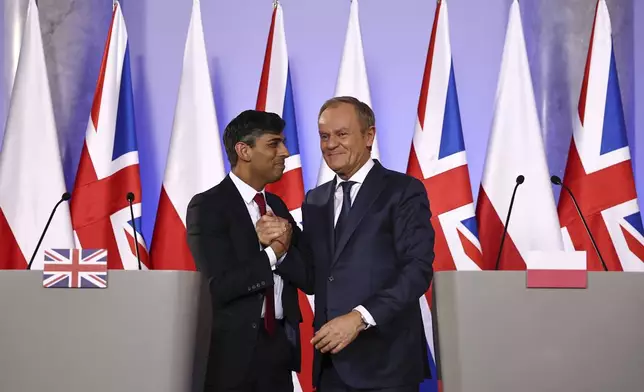 Prime Minister Rishi Sunak, left, and Polish Prime Minister Donald Tusk shake hands after addressing a press conference following bilateral talks at the Prime Minister's office in Warsaw, Poland, on Tuesday April 23, 2024. (Henry Nicholls, Pool Photo via AP)