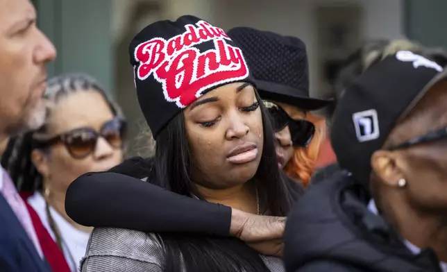Flanked by family members, attorneys and supporters, Dexter Reed's sister, Porscha Banks, cries during a news coference outside the headquarters for the Civilian Office of Police Accountability in West Town, Chicago, Tuesday, April 9, 2024. Reed, 26, was shot to death March 21 during a traffic stop by Chicago police. (Ashlee Rezin /Chicago Sun-Times via AP)