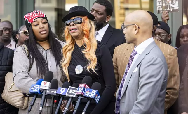 Flanked by family members, attorneys and supporters, Dexter Reed's mother, Nicole Banks, speaks to reporters outside the headquarters for the Civilian Office of Police Accountability in West Town, Chicago, Tuesday, April 9, 2024. Reed, 26, was shot to death March 21 during a traffic stop by Chicago police. (Ashlee Rezin /Chicago Sun-Times via AP)