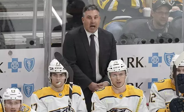 Nashville Predators head coach Andrew Brunette, center top, calls instructions to his players during the first period of an NHL hockey game against the Pittsburgh Penguins, Monday, April 15, 2024, in Pittsburgh. (AP Photo/Matt Freed)