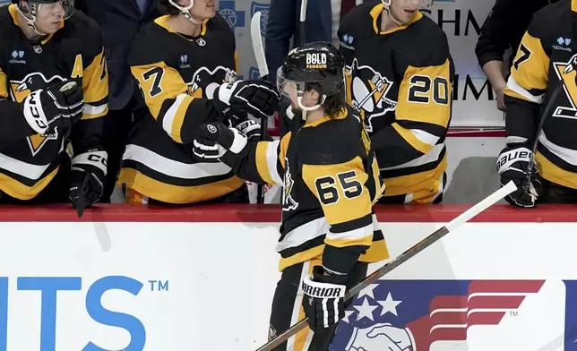 Pittsburgh Penguins' Erik Karlsson (65) returns to the bench after scoring against the Nashville Predators during the first period of an NHL hockey game, Monday, April 15, 2024, in Pittsburgh. (AP Photo/Matt Freed)