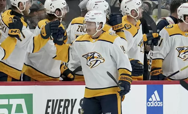 Nashville Predators' Gustav Nyquist (14) returns to the bench after scoring against the Pittsburgh Penguins during the second period of an NHL hockey game, Monday, April 15, 2024, in Pittsburgh. (AP Photo/Matt Freed)