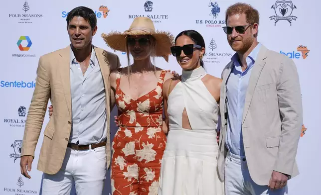 Britain's Prince Harry, right, and wife Meghan Markle, Duchess of Sussex, second right, pose for photos with Argentine professional polo player Ignacio "Nacho" Figueras, left, and his wife Delfina Blaquier as they arrive for the 2024 Royal Salute Polo Challenge to Benefit Sentebale, Friday, April 12, 2024, in Wellington, Fla. Prince Harry, co-founding patron of the Sentebale charity, will play on the Royal Salute Sentebale Team. (AP Photo/Rebecca Blackwell)