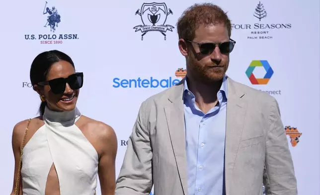 Britain's Prince Harry, right, and wife Meghan Markle, Duchess of Sussex, arrive for the 2024 Royal Salute Polo Challenge to Benefit Sentebale, Friday, April 12, 2024, in Wellington, Fla. Prince Harry, co-founding patron of the Sentebale charity, will play on the Royal Salute Sentebale Team. (AP Photo/Rebecca Blackwell)