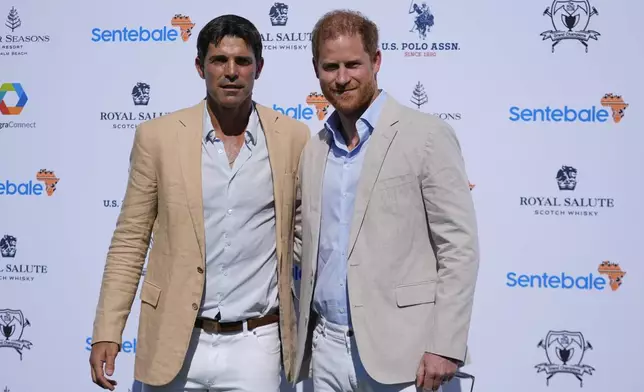 Britain's Prince Harry, right, poses with Argentine professional polo player Ignacio "Nacho" Figueras, as he arrives for the 2024 Royal Salute Polo Challenge to Benefit Sentebale, Friday, April 12, 2024, in Wellington, Fla. Prince Harry, co-founding patron of the Sentebale charity, will play on the Royal Salute Sentebale Team. (AP Photo/Rebecca Blackwell)