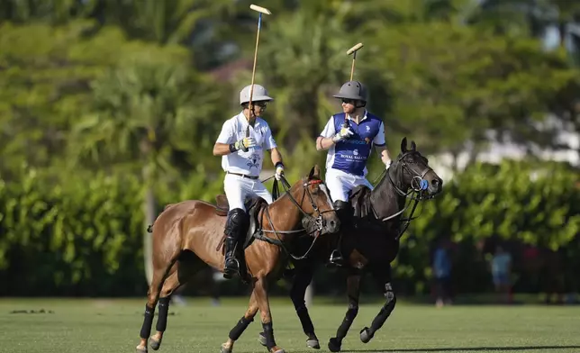 Britain's Prince Harry, right, talks with Louis Devaleix as they ride out for the start of the 2024 Royal Salute Polo Challenge to Benefit Sentebale, Friday, April 12, 2024, in Wellington, Fla. Prince Harry, co-founding patron of the Sentebale charity, will play on the Royal Salute Sentebale Team. (AP Photo/Rebecca Blackwell)