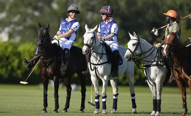 Britain's Prince Harry, left, talks with other players at the start of the 2024 Royal Salute Polo Challenge to Benefit Sentebale, Friday, April 12, 2024, in Wellington, Fla. Prince Harry, co-founding patron of the Sentebale charity, will play on the Royal Salute Sentebale Team. (AP Photo/Rebecca Blackwell)