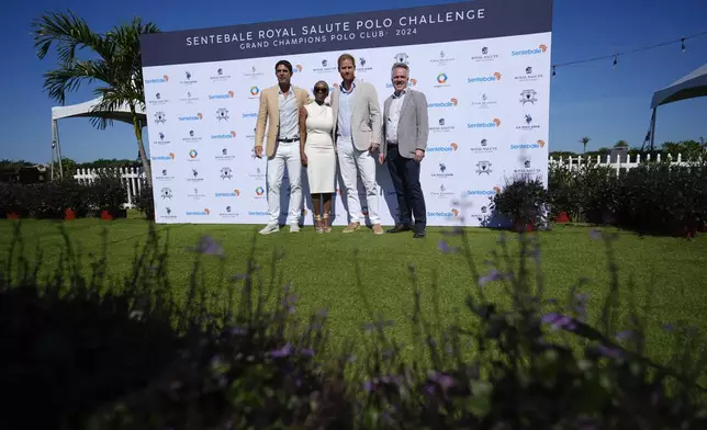 Britain's Prince Harry, center right, poses with, from left, Argentine professional polo player Ignacio "Nacho" Figueras, Sentebale Chair Sophie Chandauka, and Sentebale CEO Richard Miller, as he arrives for the 2024 Royal Salute Polo Challenge to Benefit Sentebale, Friday, April 12, 2024, in Wellington, Fla. Prince Harry, co-founding patron of the Sentebale charity, will play on the Royal Salute entebale Team. (AP Photo/Rebecca Blackwell)