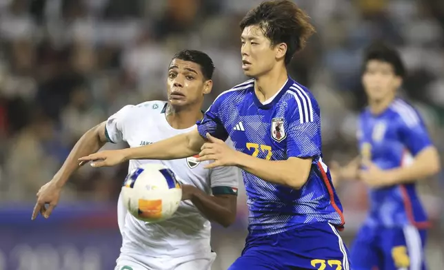 Nihad Mohammed. left, and Kota Takai run for the ball during a U-23 Asian Cup semi-final match between Iraq and Japan in Doha, Qatar, on Monday, April 29, 2024. (AP Photo/Hussein Sayed)