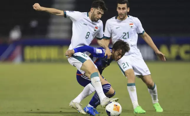 Iraq's Ali Basim Mohamed, left, and Japan's Riku Handa fight for the ball during a U-23 Asian Cup semi-final match between Iraq and Japan in Doha, Qatar, on Monday, April 29, 2024. (AP Photo/Hussein Sayed)