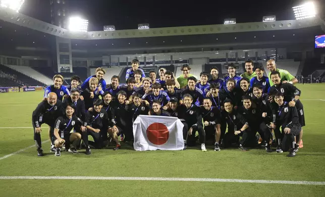 Japan's players pose for a photo after the U-23 Asian Cup semi-final match between Iraq and Japan in Doha, Qatar, on Monday, April 29, 2024. (AP Photo/Hussein Sayed)