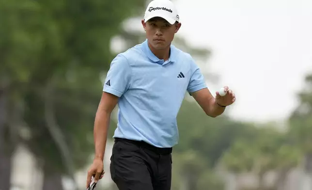 Collin Morikawa waves after making a putt on the first hole during the final round of the RBC Heritage golf tournament, Sunday, April 21, 2024, in Hilton Head Island, S.C. (AP Photo/Chris Carlson)