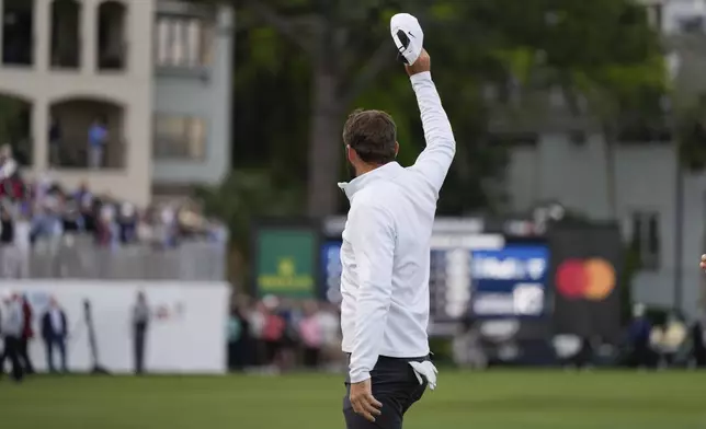 Scottie Scheffler waves after winning the weather delayed RBC Heritage golf tournament, Monday, April 22, 2024, in Hilton Head Island, S.C. (AP Photo/Chris Carlson)
