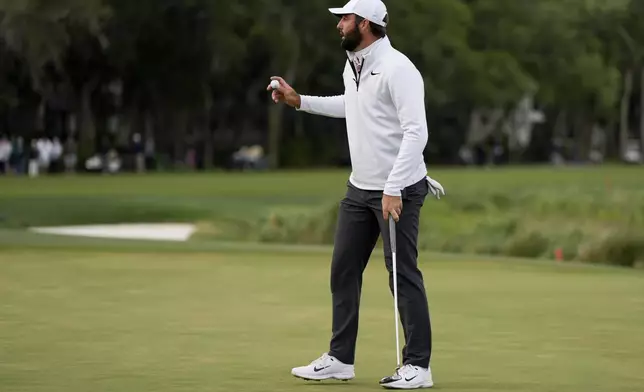 Scottie Scheffler waves after making a putt on the 16th hole during the completion of the weather delayed final round at the RBC Heritage golf tournament, Monday, April 22, 2024, in Hilton Head Island, S.C. (AP Photo/Chris Carlson)