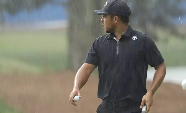 Xander Schauffele waits to play in the rain on the 15th hole during the final round of the RBC Heritage golf tournament, Sunday, April 21, 2024, in Hilton Head Island, S.C. (AP Photo/Chris Carlson)