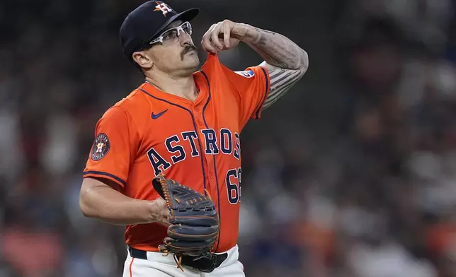 Houston Astros starting pitcher J.P. France walks around the mound after issuing a bases-loaded walk to Texas Rangers' Josh Smith during the third inning of a baseball game Friday, April 12, 2024, in Houston. (AP Photo/Kevin M. Cox)