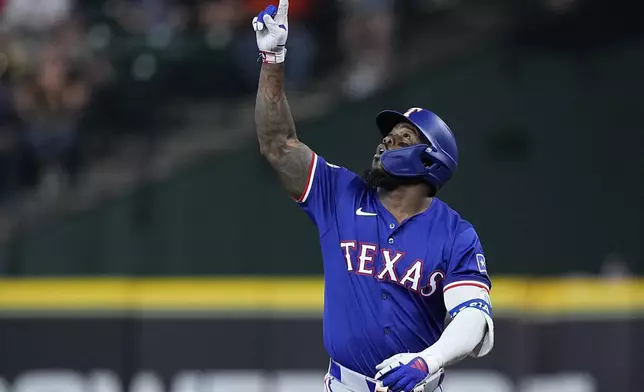 Texas Rangers' Adolis García celebrates after hitting an RBI single during the first inning of a baseball game against the Houston Astros Friday, April 12, 2024, in Houston. (AP Photo/Kevin M. Cox)