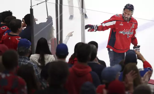 Washington Capitals left wing Alex Ovechkin (8) points to a fan after being eliminated by the New York Rangers in Game 4 of an NHL hockey Stanley Cup first-round playoff series Sunday, April 28, 2024, in Washington. (AP Photo/Tom Brenner)