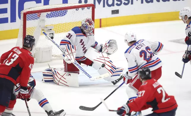 New York Rangers goaltender Igor Shesterkin (31) makes a save during the third period in Game 4 of an NHL hockey Stanley Cup first-round playoff series against the Washington Capitals Sunday, April 28, 2024, in Washington. (AP Photo/Tom Brenner)