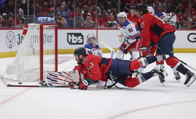 New York Rangers goaltender Igor Shesterkin makes a save as Washington Capitals right wing Tom Wilson shoots during the first period in Game 4 of an NHL hockey Stanley Cup first-round playoff series, Sunday, April 28, 2024, in Washington. (AP Photo/Tom Brenner)