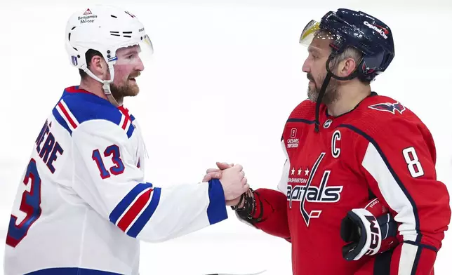 New York Rangers left wing Alexis Lafrenière (13) shakes hands with Washington Capitals left wing Alex Ovechkin (8) following Game 4 of an NHL hockey Stanley Cup first-round playoff series Sunday, April 28, 2024, in Washington. (AP Photo/Tom Brenner)
