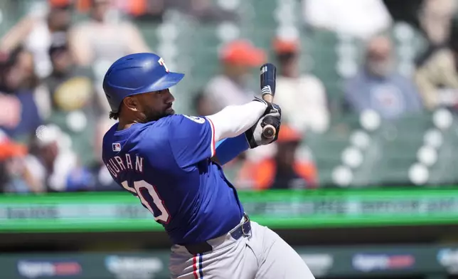 Texas Rangers designated hittere Ezequiel Duran connects for a RBI single during the fifth inning of a baseball game against the Detroit Tigers, Tuesday, April 16, 2024, in Detroit. (AP Photo/Carlos Osorio)