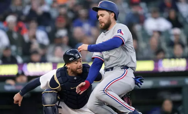 Texas Rangers' Jared Walsh is tagged out by Detroit Tigers catcher Carson Kelly during the fifth inning of a baseball game, Monday, April 15, 2024, in Detroit. (AP Photo/Carlos Osorio)