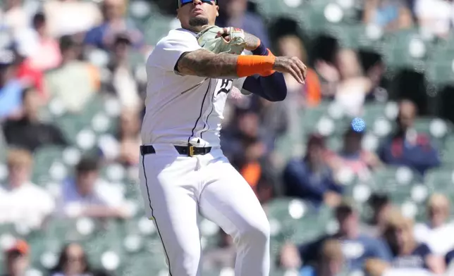 Detroit Tigers shortstop Javier Baez throw out Texas Rangers' Wyatt Langford at first during the fourth inning of a baseball game, Tuesday, April 16, 2024, in Detroit. (AP Photo/Carlos Osorio)