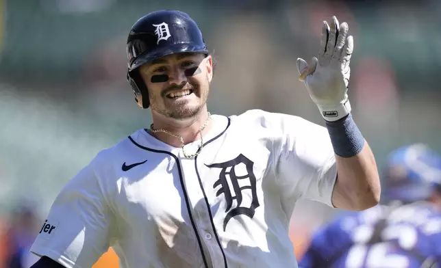 Detroit Tigers' Zach McKinstry crosses home plate to score during the sixth inning of a baseball game against the Texas Rangers, Tuesday, April 16, 2024, in Detroit. (AP Photo/Carlos Osorio)